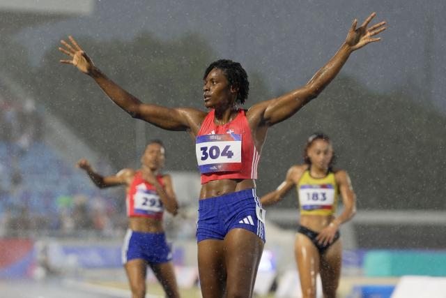 Dominican Republic's Marileidy Paulino celebrates after winning the women's 400m final during the XXV Central American and Caribbean Games at the Felix Sanchez Olympic Stadium in Santo Domingo on August 5, 2026. (Photo by Francesco SPOTORNO / AFP)