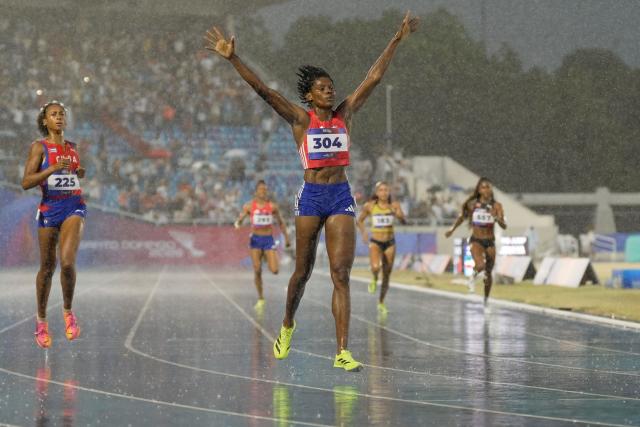 Dominican Republic's Marileidy Paulino (C) celebrates after winning the women's 400m final during the XXV Central American and Caribbean Games at the Felix Sanchez Olympic Stadium in Santo Domingo on August 5, 2026. (Photo by Francesco SPOTORNO / AFP)