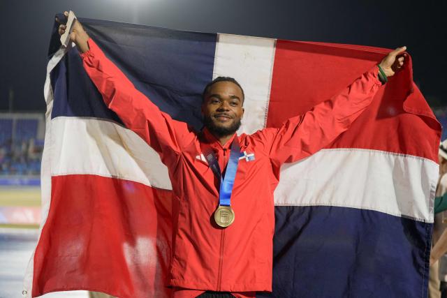 Dominican Republic's Gabriel Moronta celebrates on the podium after winning the gold medal in the men's 400m final during the XXV Central American and Caribbean Games at the Felix Sanchez Olympic Stadium in Santo Domingo on August 5, 2026. (Photo by Francesco SPOTORNO / AFP)