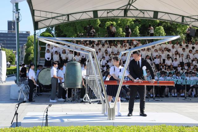 The "Peace Bell" is rung at the Peace Memorial Ceremony, marking the 81st anniversary of the atomic bombing, at the Peace Memorial Park in Hiroshima on August 6, 2026. (Photo by JIJI Press / AFP) / Japan OUT
