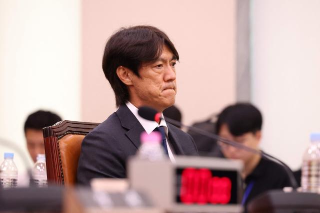 (FILES) Former South Korean men's national team head coach Hong Myung-bo attends the hearing on the Korea Football Association (KFA) over a controversy surrounding its management at the National Assembly in Seoul on July 30, 2026. Police conducted "search and seizure operations" at the Korea Football Association's offices, probing allegations of "obstruction of business" in the recruitment of former coach Hong Myung-bo, a police spokesman told AFP on August 6, 2026. (Photo by Chung Sung-Jun / POOL / AFP)
