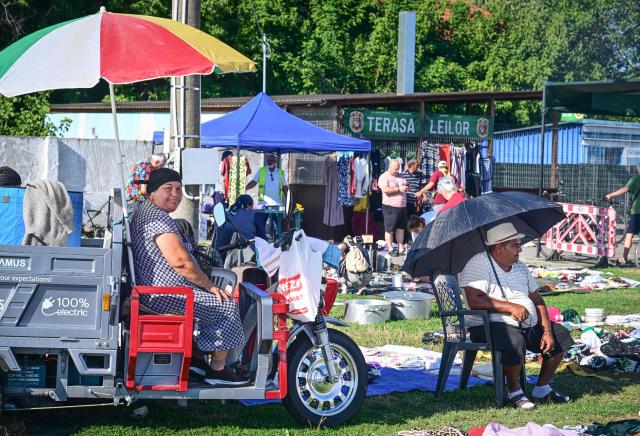 Vendors of second hand garments wait for customers at the open-air market in the city of Calarasi, Romania, on July 26, 2026. As the eastern European country has struggled for months with the highest inflation in the European Union, almost 11 percent in May, several buyers complained of rising prices which forced them to make difficult decisions about what to cut. (Photo by Daniel MIHAILESCU / AFP)