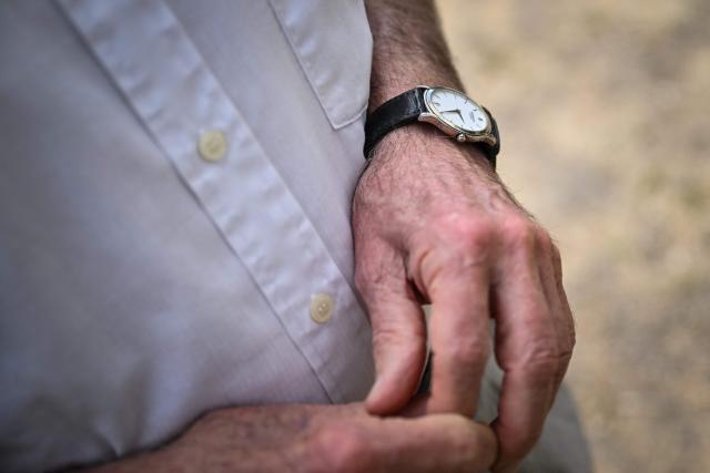 Jean, 87, stands in the communal garden of his appartment building in Colombes, suburb of Paris on August 5, 2026. On June 27, 2026 Matignon, France's Prime Minister's Office called for "everyone to remain vigilant", confirming, as previously noted by Health Minister, "an increase in the number of deaths, mainly occurring at home, consistent with a delayed peak" and linked to "the isolation of some elderly or vulnerable people." Two million additional elderly people will be automatically added to municipal registers that identify vulnerable individuals during heatwaves, under a decree published two years after the law providing for the measure was passed, the Health Ministry said in early July 2026. (Photo by Lou BENOIST / AFP)