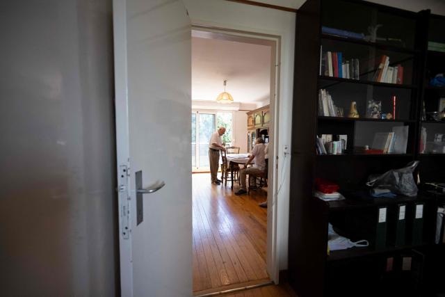 Jean, 87, stands in his appartment in Colombes, suburb of Paris on August 5, 2026. On June 27, 2026 Matignon, France's Prime Minister's Office called for "everyone to remain vigilant", confirming, as previously noted by Health Minister, "an increase in the number of deaths, mainly occurring at home, consistent with a delayed peak" and linked to "the isolation of some elderly or vulnerable people." Two million additional elderly people will be automatically added to municipal registers that identify vulnerable individuals during heatwaves, under a decree published two years after the law providing for the measure was passed, the Health Ministry said in early July 2026. (Photo by Lou BENOIST / AFP)