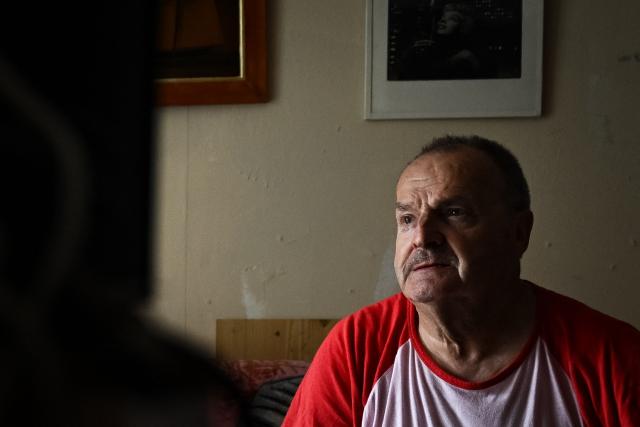 Maurice, 67, looks on at his appartment, in Colombes, suburb of Paris on August 5, 2026. On June 27, 2026 Matignon, France's Prime Minister's Office called for "everyone to remain vigilant", confirming, as previously noted by Health Minister, "an increase in the number of deaths, mainly occurring at home, consistent with a delayed peak" and linked to "the isolation of some elderly or vulnerable people." Two million additional elderly people will be automatically added to municipal registers that identify vulnerable individuals during heatwaves, under a decree published two years after the law providing for the measure was passed, the Health Ministry said in early July 2026. (Photo by Lou BENOIST / AFP)