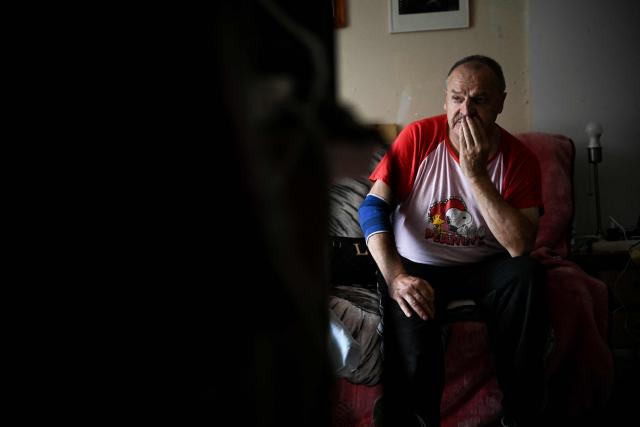 Maurice, 67, sits in his sofa at his appartment, in Colombes, suburb of Paris on August 5, 2026. On June 27, 2026 Matignon, France's Prime Minister's Office called for "everyone to remain vigilant", confirming, as previously noted by Health Minister, "an increase in the number of deaths, mainly occurring at home, consistent with a delayed peak" and linked to "the isolation of some elderly or vulnerable people." Two million additional elderly people will be automatically added to municipal registers that identify vulnerable individuals during heatwaves, under a decree published two years after the law providing for the measure was passed, the Health Ministry said in early July 2026. (Photo by Lou BENOIST / AFP)