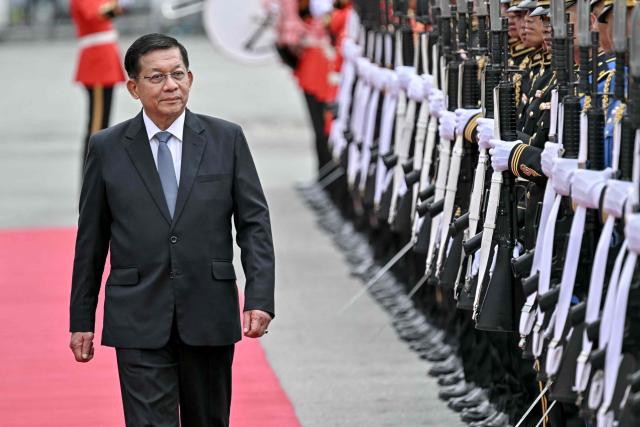 Myanmar's President Min Aung Hlaing (L) inspects a guard of honour at a welcoming ceremony during his visit at Government House in Bangkok on August 6, 2026. (Photo by Lillian SUWANRUMPHA / AFP)