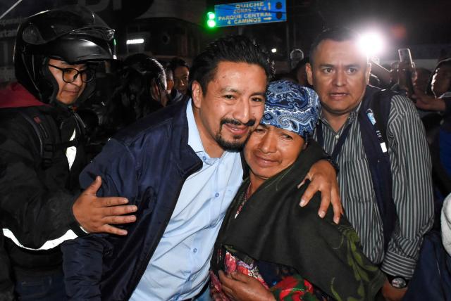 Mayan leader Hector Chaclan (C-L) is welcomed by relatives and local residents after being released from prison in Totonicapan, Guatemala, on August 5, 2026. On August 5, a Guatemalan criminal court judge granted house arrest to two Indigenous leaders considered "prisoners of conscience" by Amnesty International, after 15 months of pretrial detention for leading protests against former Attorney General Consuelo Porras. (Photo by Gustavo RODAS / AFP)