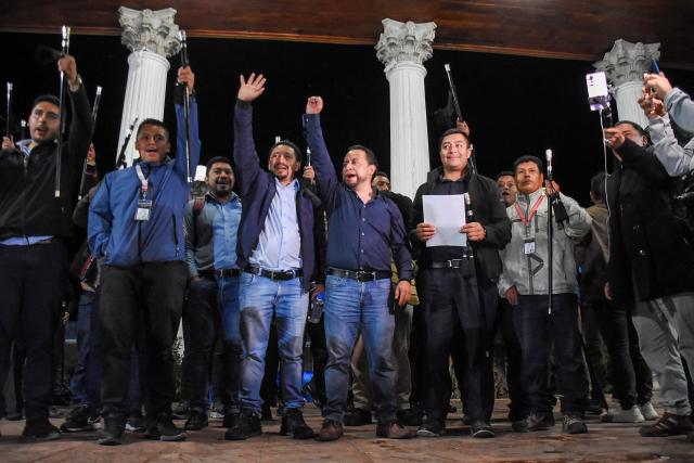 Mayan leaders Hector Chaclan (3rd-L) and Deputy Minister of Energy and Mines Luis Pacheco (4th-L) gesture after being released from prison in Totonicapan, Guatemala, on August 5, 2026. On August 5, a Guatemalan criminal court judge granted house arrest to two Indigenous leaders considered "prisoners of conscience" by Amnesty International, after 15 months of pretrial detention for leading protests against former Attorney General Consuelo Porras. (Photo by Gustavo RODAS / AFP)