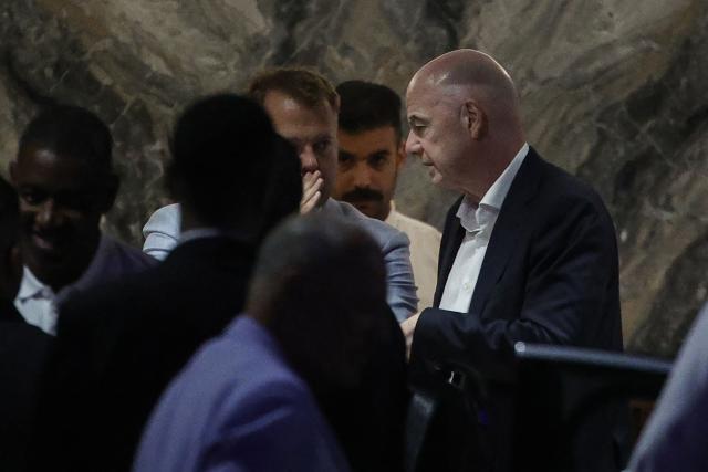 FIFA President Gianni Infantino (R) leaves Al-Madina Stadium in Rabat following the 2026 Women's Africa Cup of Nations match between Malawi and Zambia on August 5, 2026. Infantino, under fire for a now shelved plan to open the World Cup to private investment, earlier held emergency talks in Morocco with directors of the world football governing body.
FIFA then issued an apology while reaffirming its "full support" for Infantino. In a statement, the leadership acknowledged "that errors were also made after the proposal was leaked to media". (Photo by Abdel Majid BZIOUAT / AFP)