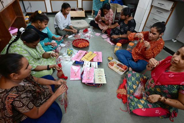 Visually impaired women prepare 'rakhis' or ceremonial wristbands, at the Andh Kanya Prakash Gruh Blind School in Ahmedabad on August 6, 2026 ahead of the upcoming Hindu festival of Raksha Bandhan. (Photo by Shammi MEHRA / AFP)