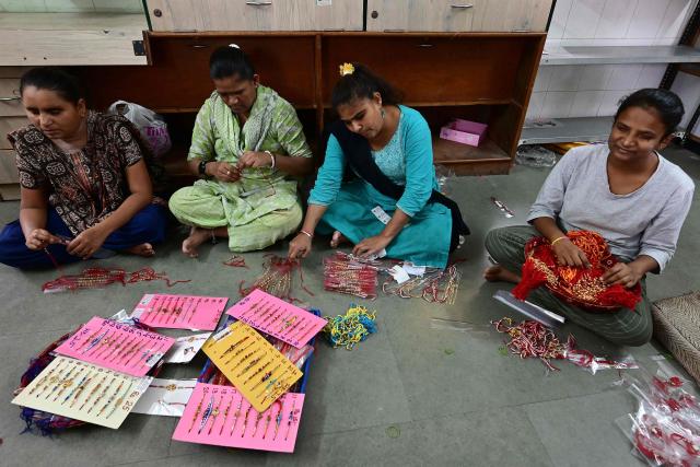 Visually impaired women prepare 'rakhis' or ceremonial wristbands, at the Andh Kanya Prakash Gruh School for the Blind in Ahmedabad on August 6, 2026 ahead of the upcoming Hindu festival of Raksha Bandhan. (Photo by Shammi MEHRA / AFP)