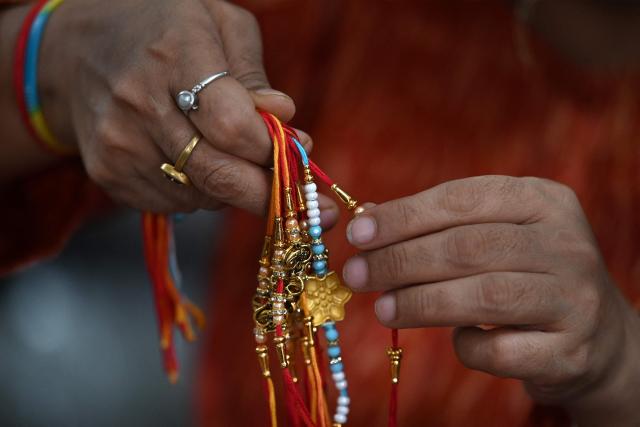 A visually impaired woman prepare 'rakhis' or ceremonial wristbands, at the Andh Kanya Prakash Gruh School for the Blind in Ahmedabad on August 6, 2026 ahead of the upcoming Hindu festival of Raksha Bandhan. (Photo by Shammi MEHRA / AFP)
