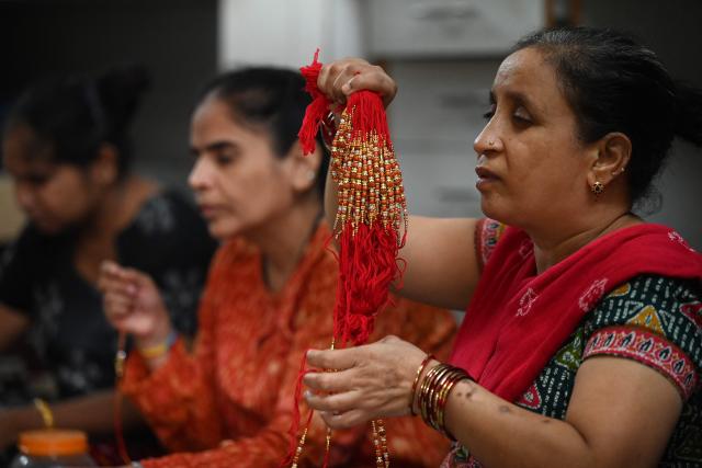 Visually impaired women prepare 'rakhis' or ceremonial wristbands, at the Andh Kanya Prakash Gruh School for the Blind in Ahmedabad on August 6, 2026 ahead of the upcoming Hindu festival of Raksha Bandhan. (Photo by Shammi MEHRA / AFP)