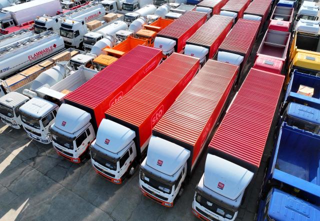 Trucks for export are seen at a port in Lianyungang, eastern China's Jiangsu province on August 6, 2026. (Photo by CN-STR / AFP) / China OUT