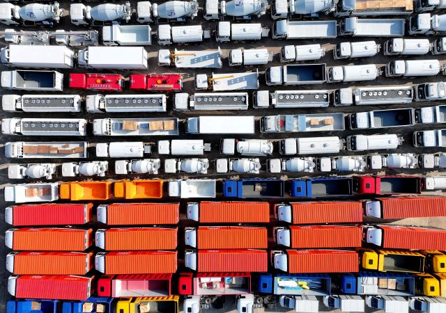 Trucks for export are seen at a port in Lianyungang, eastern China's Jiangsu province on August 6, 2026. (Photo by CN-STR / AFP) / China OUT