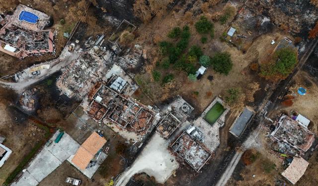 This aerial photograph shows burnt properties in an area hit by the wildfire that swept through the Gironde region in Le Porge, south-western France on August 6, 2026. Around 240 homes were destroyed by the flames, three-quarters of them in the municipality of Le Porge (population 3,500), according to a provisional assessment. No fatalities or civilian injuries have been reported. (Photo by Christophe ARCHAMBAULT / AFP)