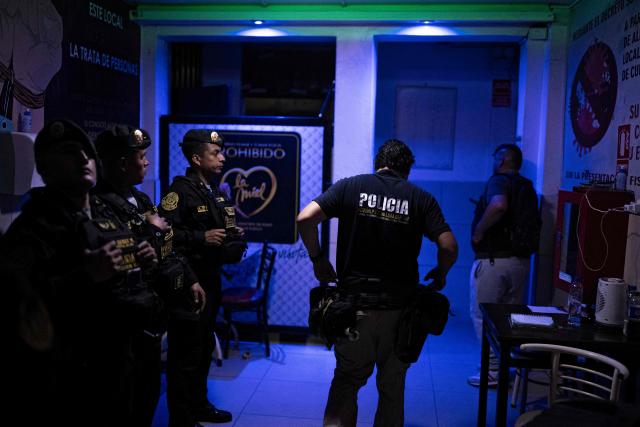 Members of the Peruvian National Police conduct an anti-human trafficking operation called Sodom and Gomorrah at La Miel brothel, in the Independencia district, on the northern outskirts of Lima on July 31, 2026 late night. (Photo by ERNESTO BENAVIDES / AFP)