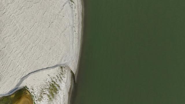 This aerial photograph shows sandbanks exposed by the receding waters of the Po River in Isola Pescaroli, northern Italy, on August 6, 2026. (Photo by Stefano RELLANDINI / AFP)