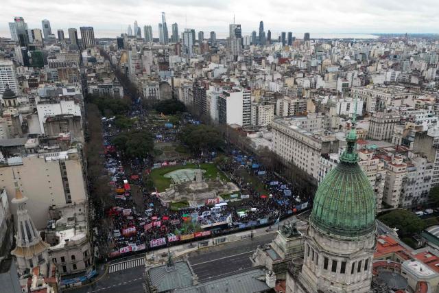 Aerial view showing demonstrators protesting outside the National Congress in Buenos Aires on August 6, 2026, as senators debate the bill on the inviolability of private property. (Photo by Luis ROBAYO / AFP)