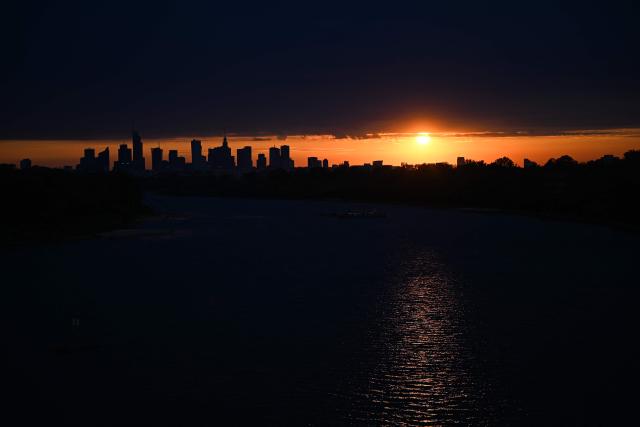Warsaw's skyscrapers are silhouetted as the sun sets over the Vistula River in Warsaw on August 6, 2026. (Photo by Sergei GAPON / AFP)