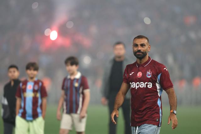 Trabzonspor's Egyptian forward Mohamed Salah walks on the pitch during his signing cerenomy at the Papara Park Stadium in Trabzon on August 6, 2026. Former Liverpool star Mohamed Salah on August 6, 2026 signed a two-year contract with Turkish club Trabzonspor after leaving the Premier League giants at the end of his contract. (Photo by Nurgul GUNAYDIN / AFP)