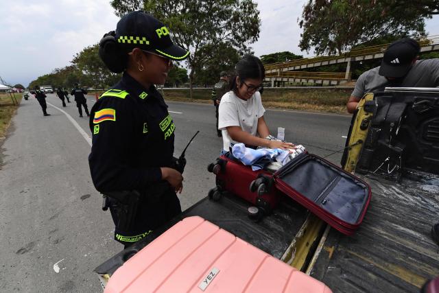 Police officers inspect a vehicle and its occupants during a security checkpoint operation on the road linking Alfonso Bonilla Aragon International Airport to the city of Cali, Colombia, on August 6, 2026, on the eve of the inauguration of Colombian president-elect Abelardo de la Espriella. (Photo by Jaime SALDARRIAGA / AFP)