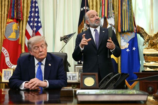 US President Donald Trump listen to US Secretary of Commerce Howard Lutnick speak after he signed an executive order on adjusting imports of polysilicon in the Oval Office of the White House in Washington, DC, on August 7, 2026. (Photo by Jim WATSON / AFP)