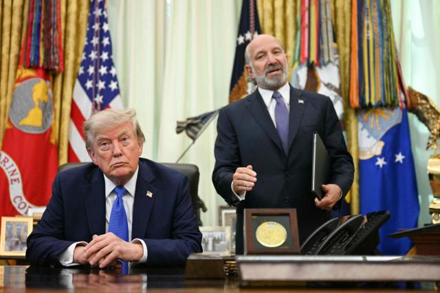 US President Donald Trump listen to US Secretary of Commerce Howard Lutnick speak after he signed an executive order on adjusting imports of polysilicon in the Oval Office of the White House in Washington, DC, on August 7, 2026. (Photo by Jim WATSON / AFP)