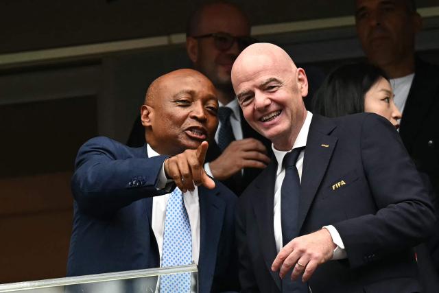 (FILES) Confederation of African Football (CAF) President Patrice Motsepe (L) points out as he talks with FIFA President Gianni Infantino (R) ahead of the 2026 World Cup round of 16 football match between Canada and Morocco at the Houston Stadium in Houston on July 4, 2026. The Executive Committee of the Confederation of African Football (CAF) “unanimously reaffirmed its support” for FIFA President Gianni Infantino on August 6, 2026, following the controversy surrounding his plan to open the organisation up to private investors, which was ultimately abandoned. (Photo by Paul ELLIS / AFP)