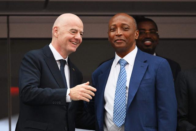 (FILES) FIFA President Gianni Infantino (L) and Confederation of African Football (CAF) President Patrice Motsepe (R) talk ahead of the 2026 World Cup round of 32 football match between South Africa and Canada at the Los Angeles Stadium in Inglewood on June 28, 2026. The Executive Committee of the Confederation of African Football (CAF) “unanimously reaffirmed its support” for FIFA President Gianni Infantino on August 6, 2026, following the controversy surrounding his plan to open the organisation up to private investors, which was ultimately abandoned. (Photo by Patrick T. Fallon / AFP)