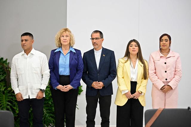 Venezuela's government delegation members (L-R) Pedro Infante, Ana Maria San Juan, Jorge Arreaza, Genesis Garvett and America Perez, pose for an official photo before the launch of Venezuela's political dialogue process at the Conventions Center in La Carlota neighborhood, Sucre municipality, Caracas on August 6, 2026. US-backed political transition talks between Venezuela's interim government and opposition representatives began on August 6, 2026 in Caracas, an AFP photographer in attendance observed. (Photo by Federico PARRA / AFP)