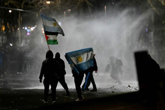 Police disperse the demonstrators with a water cannon during a protest near the National Congress in Buenos Aires on August 6, 2026, as senators debate a bill on the inviolability of private property. (Photo by Luis ROBAYO / AFP)