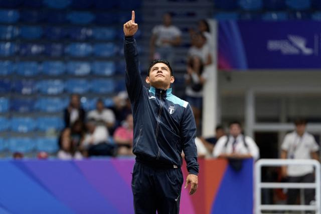 Guatemala's Jorge Vega celebrates on the podium after winning the gold medal in the men's vault final during the XXV Central American and Caribbean Games in Santo Domingo on August 6, 2026. (Photo by Francesco SPOTORNO / AFP)