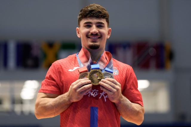 Puerto Rico's Francisco Velez poses with his medals during the XXV Central American and Caribbean Games in Santo Domingo on August 6, 2026. (Photo by Francesco SPOTORNO / AFP)