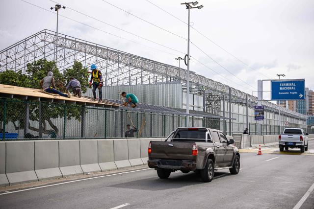 Workers carry out construction work on the structure of a new passenger area at Simon Bolivar International Airport in La Guaira, Venezuela, on August 6, 2026. (Photo by Maxwell BRICENO / AFP)