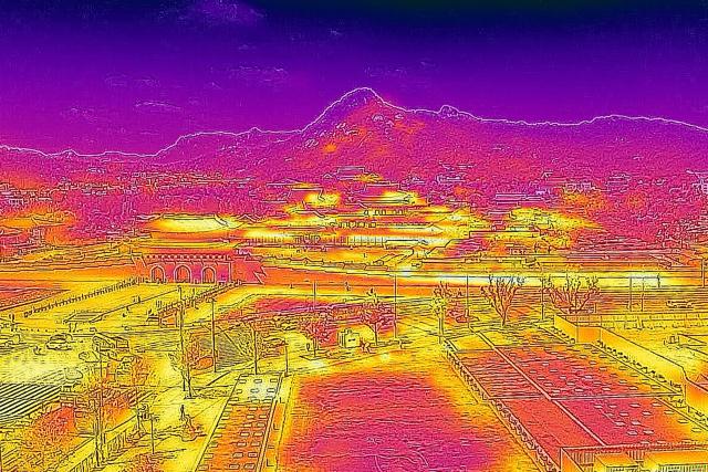 This image made with a thermal camera shows the Gyeongbokgung Palace and mountains behind, on a hot day in Seoul on August 6, 2026. South Korea has been sweltering in a streak of searing weather -- new all-time highs were set three times over the past week alone, peaking at 42.5C on August 2. (Photo by Greg Baker / AFP)