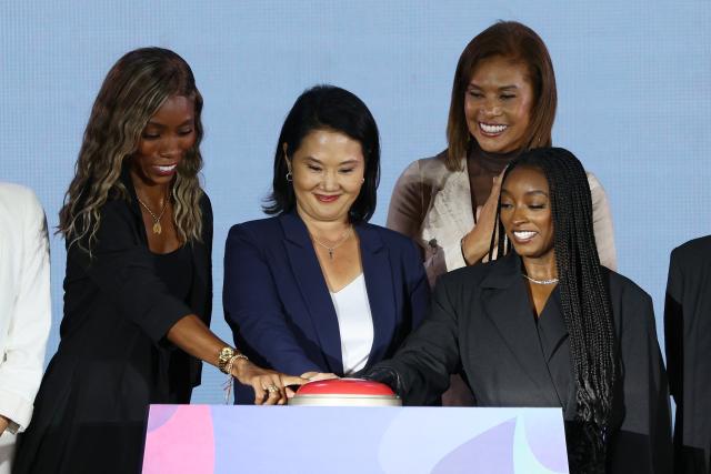 Peru's President Keiko Fujimori (C), Colombian Paralympic athlete Karen Palomeque (L), and US gymnast Simone Biles (R) push the button during the official countdown celebrations marking one year until the 2027 Pan American Games in Lima on August 6, 2026. (Photo by Connie FRANCE / AFP)