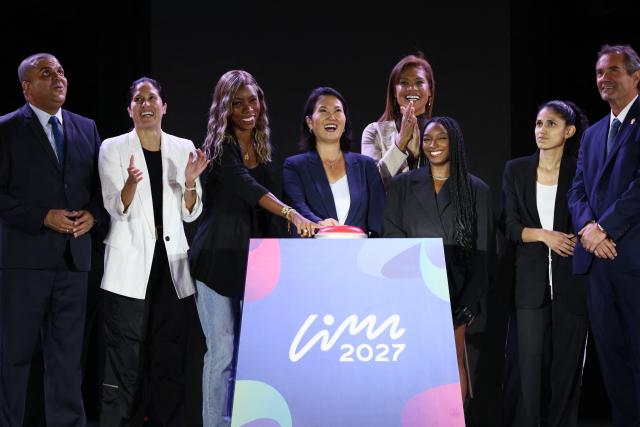 Peru's President Keiko Fujimori (C), Colombian Paralympic athlete Karen Palomeque (L), and US gymnast Simone Biles (R) push the button alongside  President of the Pan American Sports Organization Neven Ilic (R) President of the Paralympic Committee of the Americas Julio Cesar Avila (L) and during the official countdown celebrations marking one year until the 2027 Pan American Games in Lima on August 6, 2026. (Photo by Connie FRANCE / AFP)