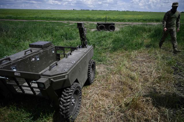A Ukrainian serviceman of the 65th Mechanized Brigade attends a field test of the off-road capabilities of a ground drone in an undisclosed location in Zaporizhzhia region on June 5, 2026, amid the Russian invasion of Ukraine. Autonomous ground drone vehicles that crawl the "kill zone" - the kilometres-deep stretch of territory where Russian and Ukrainian drones lurk in the skies, posing a constant danger to anybody below. Ukraine has built a sprawling drone industry from scratch, hailed by President Volodymyr Zelensky as the best in the world, but the dismissal of popular defence minister Mykhailo Fedorov - one of the most ardent backers of drones - raised some concerns over the future of the sector. (Photo by Genya SAVILOV / AFP)