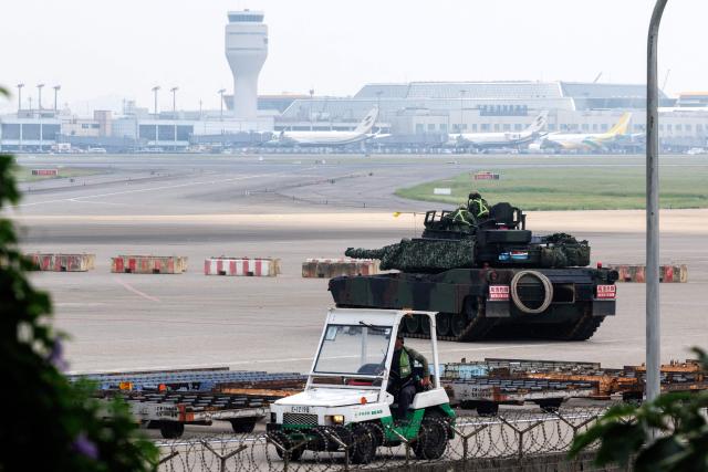 A Taiwanese military M1A2T tank is pictured during a drill simulating an enemy airborne assault at Taiwan Taoyuan International Airport in Taoyuan on August 7, 2026. Taiwan's largest military drills of the year began on August 5 as the island democracy attempts to prepare its population for a potential Chinese invasion. (Photo by CHENG Yu-chen / AFP)