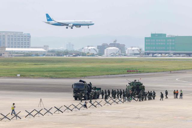 Taiwanese soldiers set up defensive obstacles during a civil-military drill simulating an enemy airborne assault at Taiwan Taoyuan International Airport in Taoyuan on August 7, 2026. Taiwan's largest military drills of the year began on August 5 as the island democracy attempts to prepare its population for a potential Chinese invasion. (Photo by CHENG Yu-chen / AFP)