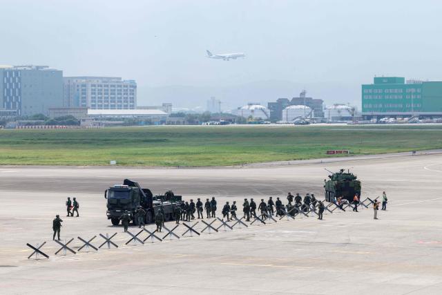 Taiwanese soldiers set up defensive obstacles during a civil-military drill simulating an enemy airborne assault at Taiwan Taoyuan International Airport in Taoyuan on August 7, 2026. Taiwan's largest military drills of the year began on August 5 as the island democracy attempts to prepare its population for a potential Chinese invasion. (Photo by CHENG Yu-chen / AFP)