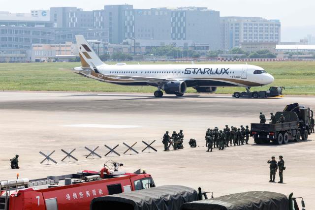 Taiwanese soldiers set up defensive obstacles during a civil-military drill simulating an enemy airborne assault at Taiwan Taoyuan International Airport in Taoyuan on August 7, 2026. Taiwan's largest military drills of the year began on August 5 as the island democracy attempts to prepare its population for a potential Chinese invasion. (Photo by CHENG Yu-chen / AFP)