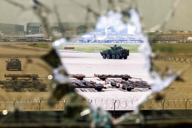 A Taiwanese military Clouded Leopard armoured vehicle moves across the tarmac during a drill simulating an enemy airborne assault at Taiwan Taoyuan International Airport in Taoyuan on August 7, 2026. Taiwan's largest military drills of the year began on August 5 as the island democracy attempts to prepare its population for a potential Chinese invasion. (Photo by CHENG Yu-chen / AFP)