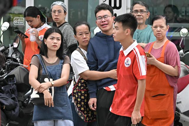 TOPSHOT - People gather outside a school following a shooting in Bang Kruai district, Nonthaburi province, north of Thailand's capital Bangkok, on August 7, 2026. Two people were killed and 15 wounded in a school shooting in a province just north of the Thai capital Bangkok on August 7, local media reported. (Photo by Lillian SUWANRUMPHA / AFP)