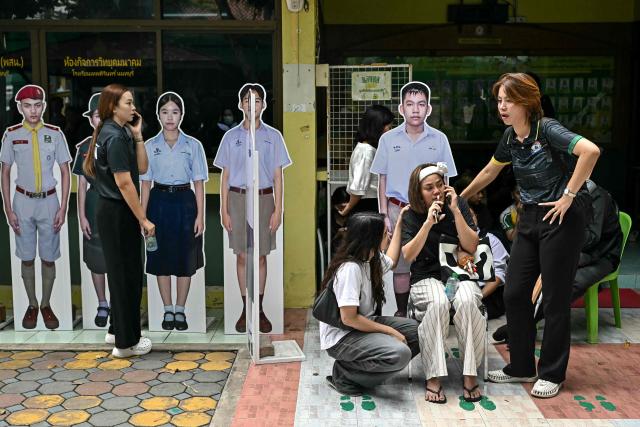 TOPSHOT - People react following a school shooting in Bang Kruai district, Nonthaburi province, north of Thailand's capital Bangkok, on August 7, 2026. At least two people were killed and several others wounded in a school shooting north of the Thai capital Bangkok on August 7, a Nonthaburi provincial official told AFP. (Photo by Lillian SUWANRUMPHA / AFP)