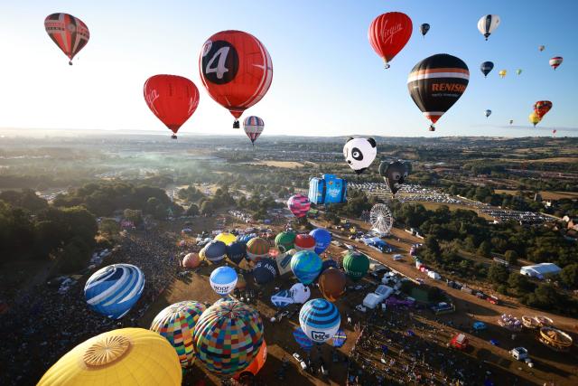 Hot air balloons take to the air in a Mass Ascent at dawn during the Bristol international balloon fiesta, in Bristol, western England on August 7, 2026. (Photo by Henry NICHOLLS / AFP)
