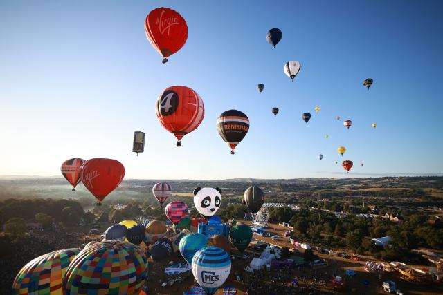 Hot air balloons take to the air in a Mass Ascent at dawn during the Bristol international balloon fiesta, in Bristol, western England on August 7, 2026. (Photo by Henry NICHOLLS / AFP)