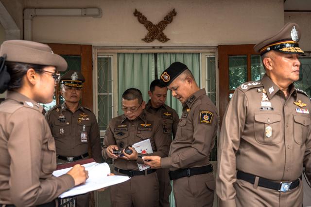 Police gather outside the house where a teenage suspect is suspected of killing his grandparents before carrying out a school shooting in Nonthaburi province, north of Thailand's capital Bangkok, on August 7, 2026. A teenage suspect killed his grandparents before shooting dead at least six more people at a school near Bangkok on August 7, police said. (Photo by Chanakarn LAOSARAKHAM / AFP)